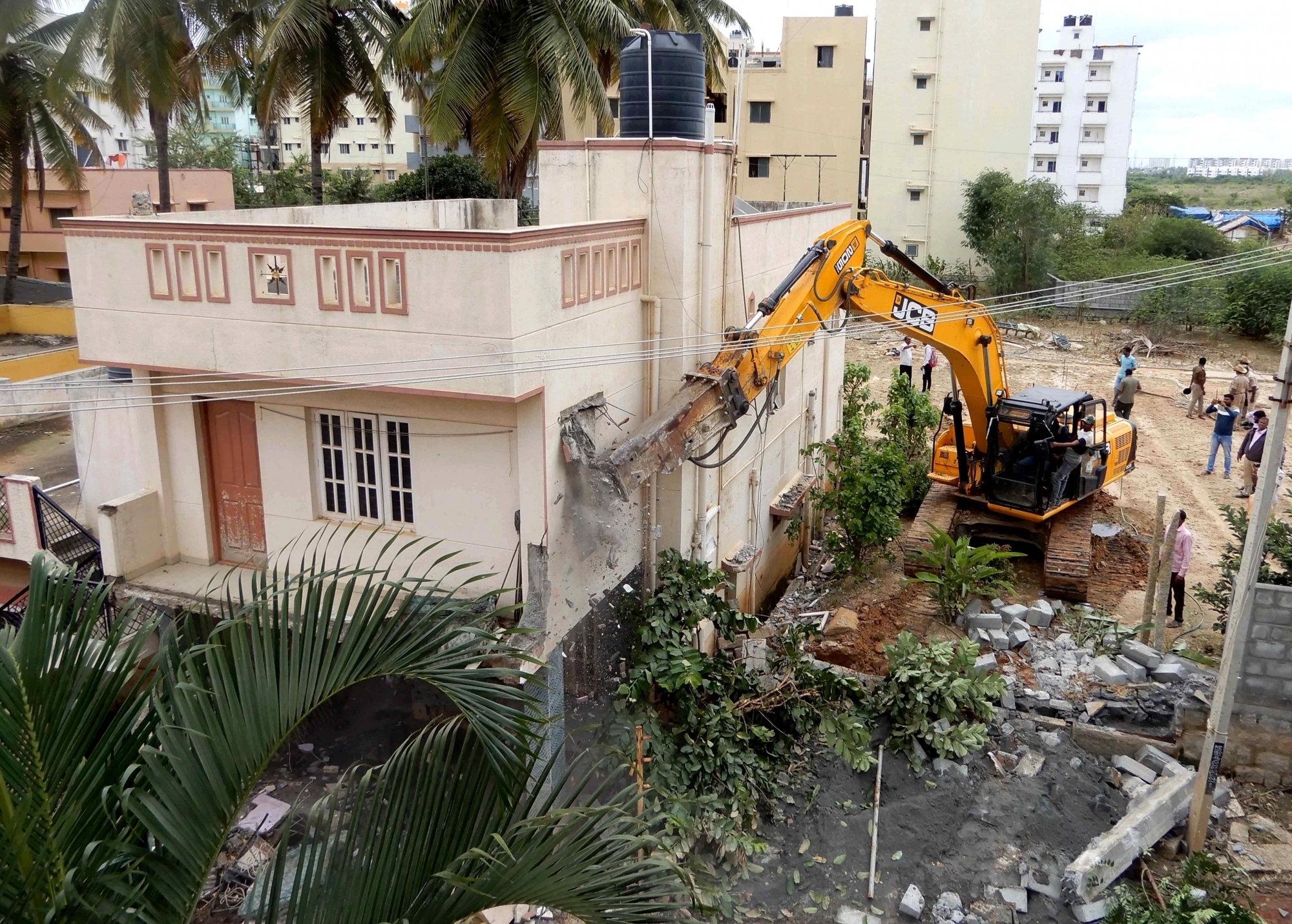 Bengaluru:BBMP started demolition of the residence and buildings constructed encroaching drains at Shanti Niketan layout, which was recently flooded due to heavy rainfall , in Bengaluru